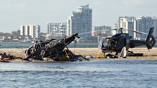 Police inspect a helicopter at the scene of the fatal crash.