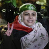 Aseel al-Titi, wearing a Hamas headband, a former Palestinian prisoner who was released by the Israeli authorities, is greeted by friends and family members in Balata.