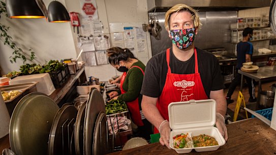 Luke Cornelissen with staff preparing take away and delivery meals at Thornbury Lentil  As Anything. 