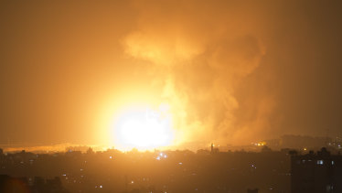 An explosion from Israeli airstrikes hits Gaza City early on Thursday. 