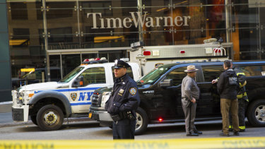 An officer keeps watch in front of the Time Warner Building after an explosive device was removed in October.