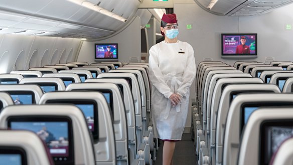 A flight attendant wearing protective equipment on board Qatar Airways. Akbar Al Baker, chief executive of the airline, says the pandemic will force a mindset shift similar to how 9/11 transformed aviation security procedures. 