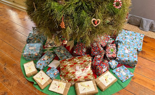 The author’s Christmas tree adorned with gifts and baubles. (Just watch out for the latter – they fall like rocks.)