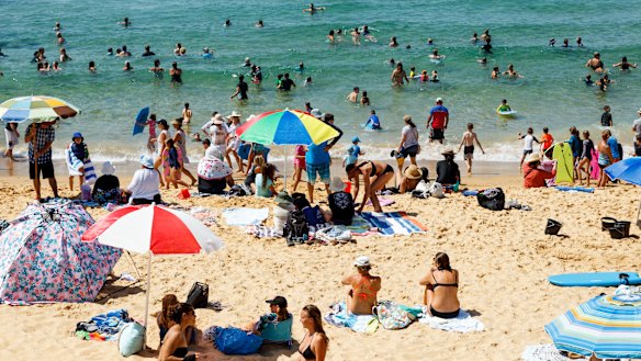 Beachgoers flock to Newcastle's Bar Beach on Friday morning. 