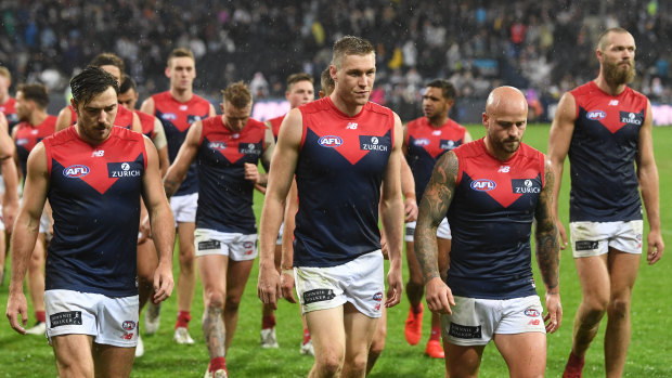 The Dees leave the field after their loss to Geelong.