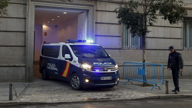 A Spanish National Police van, believed to be carrying Catalonian politicians and activists, arrives at the Spanish Supreme Court in Madrid on Wednesday.