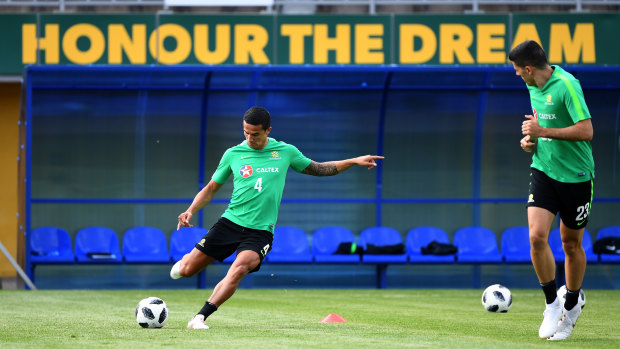 On for young and old: Veteran Tim Cahill puts in some work in camp alongside emerging Socceroos star Tom Rogic.