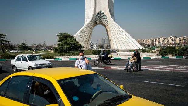 A pedestrian wears a protective face mask in Tehran, Iran.