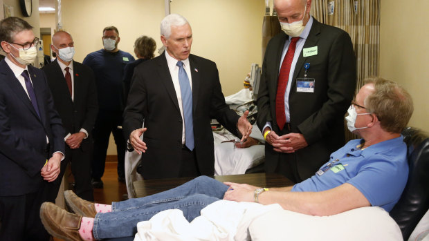 Vice President Mike Pence, centre, visits a patient who survived the coronavirus and was going to give blood during a tour of the Mayo Clinic in Rochester, Minnesota.