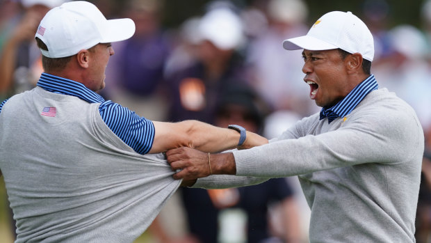 Back in it: Tiger Woods and Justin Thomas  celebrate their victory on Friday.