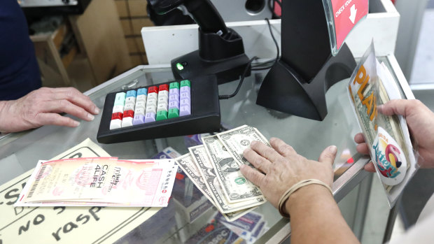 A customer purchases lottery tickets at La Preferida Superdiscount store in Hialeah, Florida.