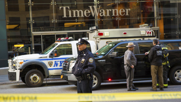 An officer keeps watch in front of the Time Warner Building, where NYPD personnel removed an explosive device on Wednesday in New York.