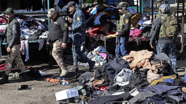 Security forces work at the site of a deadly bomb attack in Baghdad, Iraq.