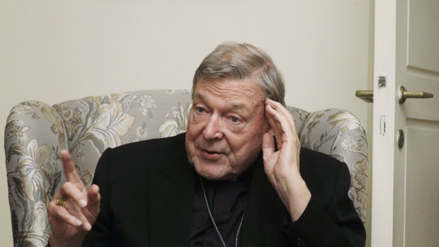 Cardinal George Pell answers a journalist's question during an interview inside his residence near the Vatican in Rome.