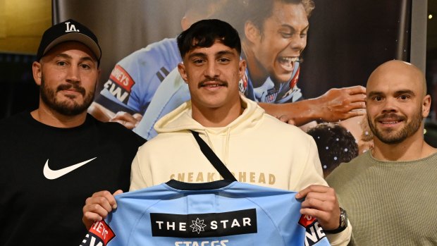 Kotoni Staggs recveives his NSW Blues jersey from his uncle Trent (left) and one of his coaches, Aidan Ryan.
