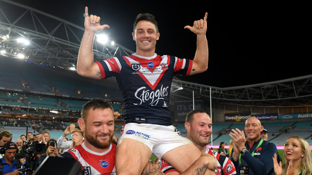 Cooper Cronk of the Roosters is carried-off the field following his team's win over the Canberra Raiders in the 2019 NRL grand final. 
