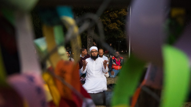 Mufti Zeeyad Ravat from Melbourne leads the crowd in a prayer near the Al Noor Mosque in Christchurch. 