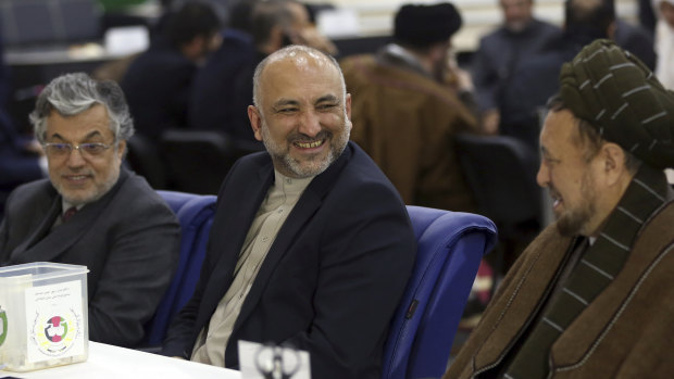 Former national security adviser Mohammad Hanif Atmar (centre) and his running mates Yunus Qanuni and Mohammad Mohaqia register at the Independent Elections Commission in Kabul on Friday. 