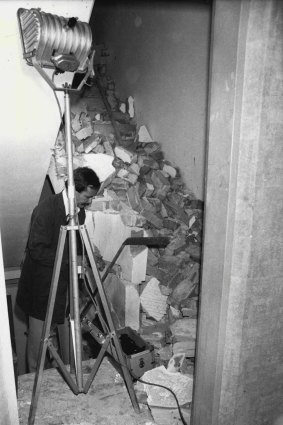 A police scientist at the site of the Westfield Towers explosion. The bomb blew a hole through the concrete floor.