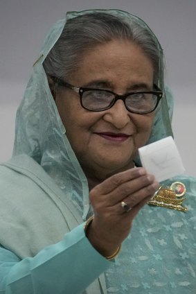 Bangladesh Prime Minister Sheikh Hasina shows her ballot paper as she casts her vote.