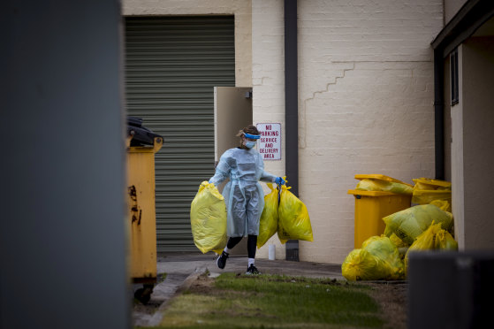 A worker disposes of hazardous waste during a deep clean at St Basil's on July 28. 