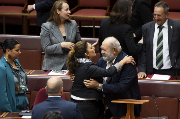 Senator Pat Dodson is embraced by Senator Lidia Thorpe after delivering his valedictory speech in the Senate on November 2023.