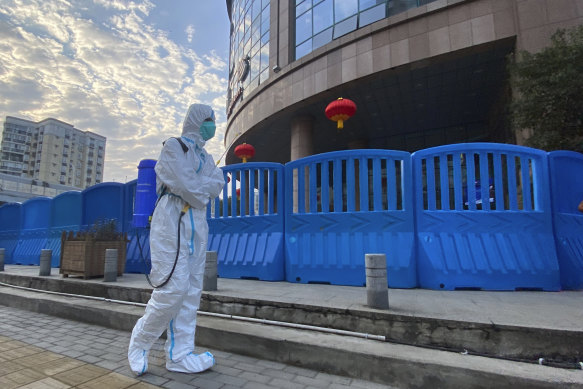 A worker with disinfecting equipment outside Wuhan Central Hospital in February.