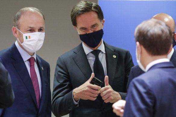 Dutch Prime Minister Mark Rutte, centre, gives the thumbs up as he speaks with French President Emmanuel Macron, right, and Irish Prime Minister Micheal Martin, left, at the Brussels summit on Tuesday.