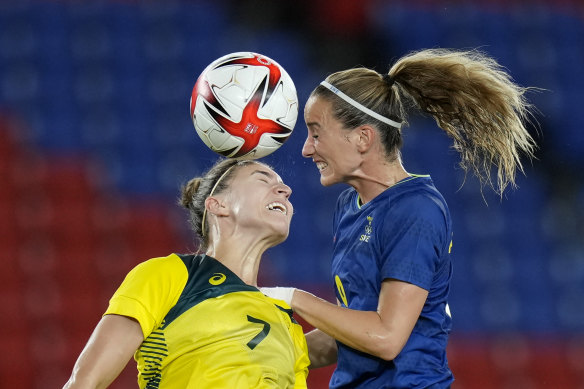 Steph Catley (left) and Sweden’s Kosovare Asllani contest the ball.