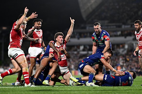 Dolphins players celebrate Jack Bostock’s late try in their upset win over the Warriors.