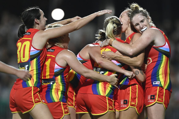 Coast with the most: Georgia Clayden of the Suns celebrates after kicking a goal.