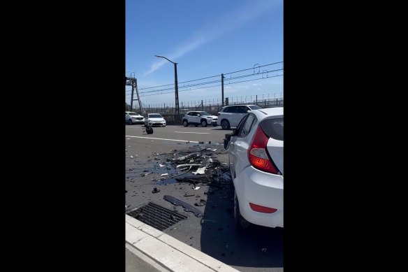 One person is dead after a bus and three cars collided on Sydney Harbour Bridge.