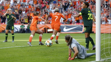 Lieke Martens and Shanice van de Sanden celebrate after another Netherlands goal as Sam Kerr looks on in dismay.