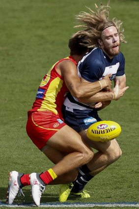 Caught: Cameron Guthrie of the Cats is tackled.