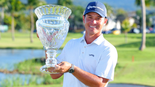 Karl Vilips of Australia poses with the winner’s trophy.