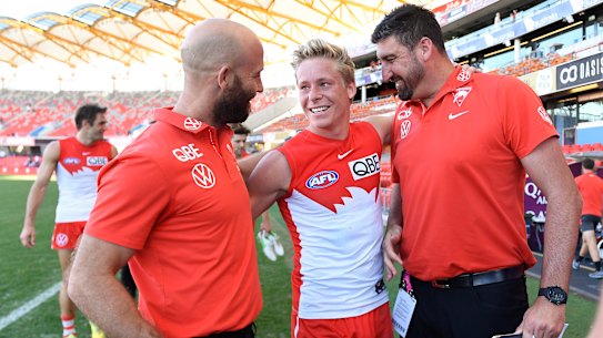Swans star Isaac Heeney with assistants Jarrad McVeigh and Dean Cox.