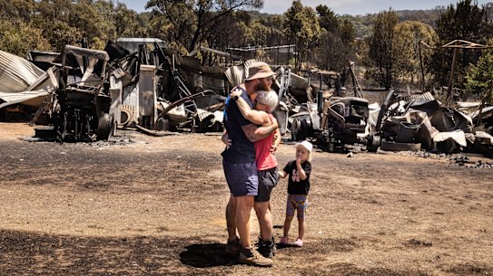 CFA volunteer Raewyn Rice greets her son after fighting fires all night and returns to her own home to find it a twisted, blackened ruin.