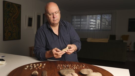 Institute of Aboriginal and Torres Strait Islander Studies chief executive Craig Ritchie with Indigenous stone tools.