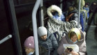People sit inside a bus waiting to be evacuated to Russia amid crisis in Donetsk, the territory controlled by pro-Russian militants, eastern Ukraine, Friday, Feb. 18, 2022.