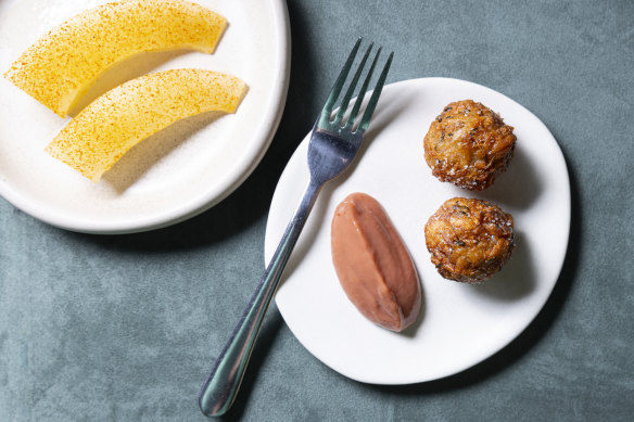 The go-to dish of melon with chilli vinegar (left), and “unmissable” taro fritters with hot sauce.