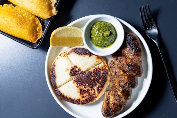 House–made chorizo with arepa (corn flatbread) and cheese and corn empanadas (top left).