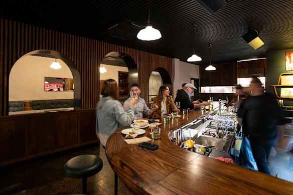 Nobody’s Baby’s curvaceous bar. Arches separate the bar area from the lounge’s booths and banquettes.