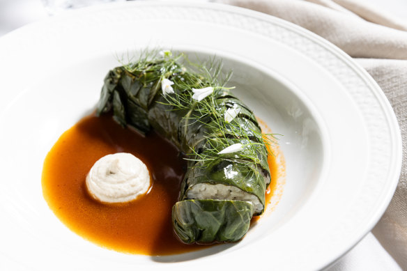 Rice-stuffed savoy cabbage leaves in roasted cabbage broth with cashew puree.