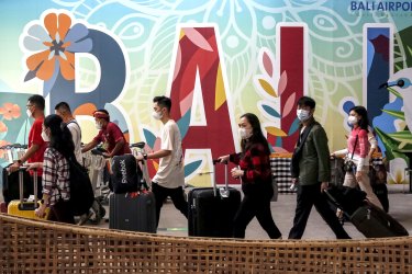 BALI, INDONESIA - DECEMBER 22: Domestic tourists arrives ahead Christmas and New Year holiday season amid Covid-19 pandemic at I Gusti Ngurah Rai Airport in Kuta, Bali, Indonesia on December 22, 2021. The Indonesian tourism minister predicts at least 150,000 domestic tourists will flocks into Bali during holiday season. However, only people with full dose of vaccine who allowed to travel starting December 24th to January 2nd in order to prevent the spreads of Covid-19, Indonesian central government says. (Photo by Johannes P. Christo/Anadolu Agency via Getty Images) Getty image for Traveller. Subscription.