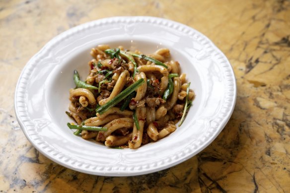 East meets West in a bowl of casarecce with Lao sausage, snake beans and garlic chives.