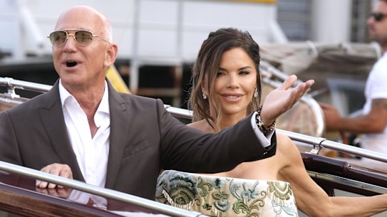 Jeff Bezos, left, and Lauren Sanchez leave their pre-wedding reception, in Venice, Italy.