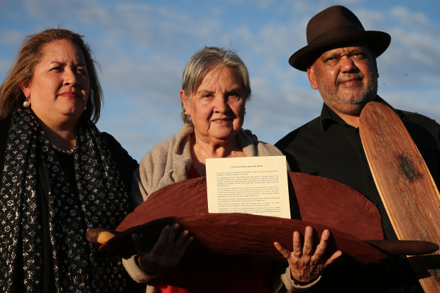 Megan Davis, Pat Anderson and Noel Pearson with a piti holding the Uluru Statement from the Heart.