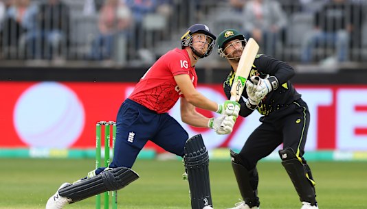 England’s Jos Buttler and Matthew Wade of Australia watch the ball go for six at Optus Stadium.