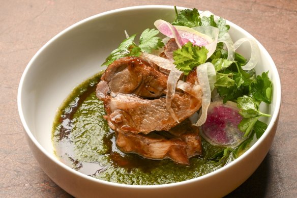 Lamb neck is showered with herbs and thinly sliced radish and served with a pert green mole.