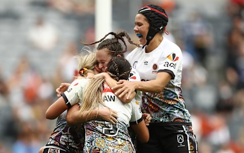 Jaime Chapman is swamped after scoring a try for the Indigenous All Stars against the Maori at CommBank Stadium.